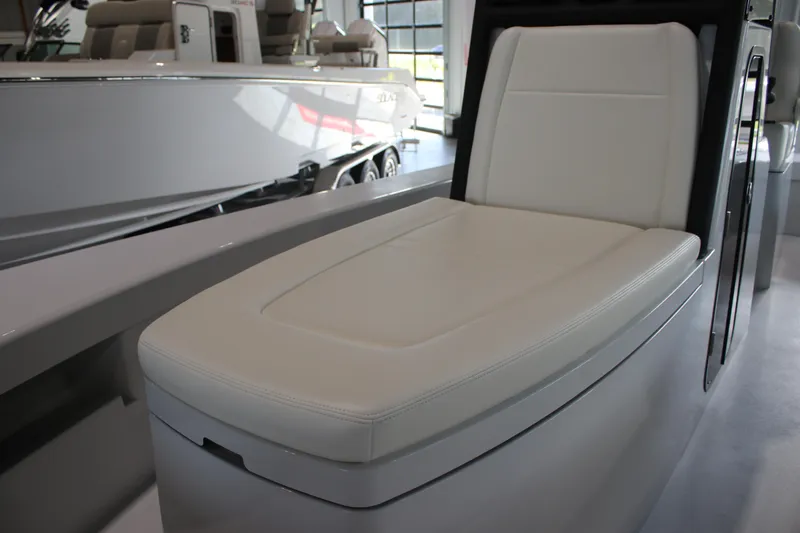 Slide: The Image of 2025 East Cape 25 Open boat interior with white cushioned seating. - 17