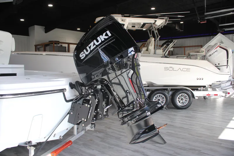 Slide: The Image of 2025 East Cape 25 Open boat with Suzuki outboard motor in showroom. - 26