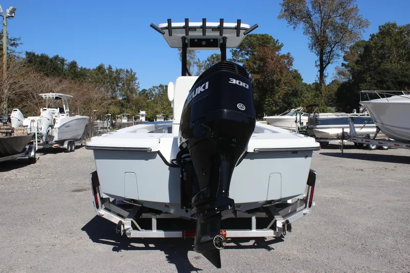 Slide: The Image of 2025 East Cape 25 Open boat with Suzuki 300 engine on trailer, parked outdoors. - 4