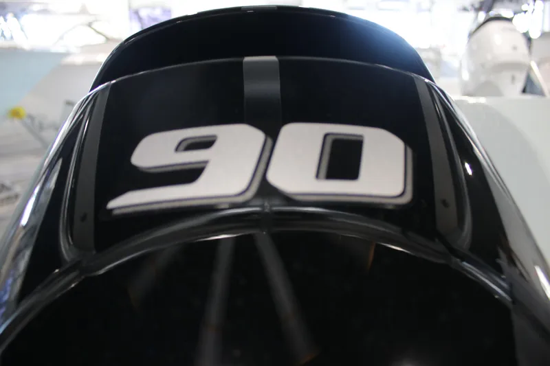 Slide: The Image of Close-up of 2025 East Cape EVO 18V outboard motor with '90' decal. - 13