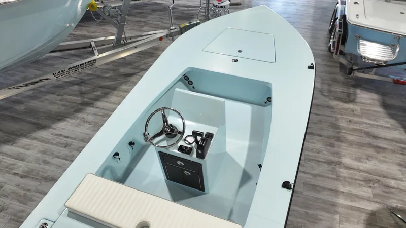 Slide: The Image of 2025 East Cape EVO 18V boat interior with steering wheel and seating on display. - 3