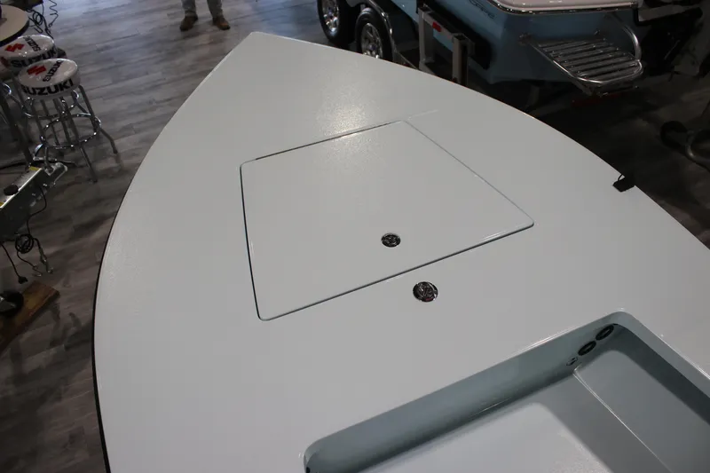 Slide: The Image of 2025 East Cape EVO 18V boat deck with storage compartment, displayed indoors. - 5