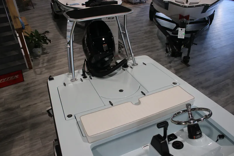 Slide: The Image of 2025 East Cape EVO 18V boat interior with steering console and motor, displayed indoors. - 8