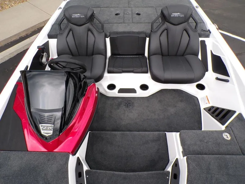 Slide: The Image of 2025 Skeeter ZXR21SE boat interior with black seats and red dashboard. - 17