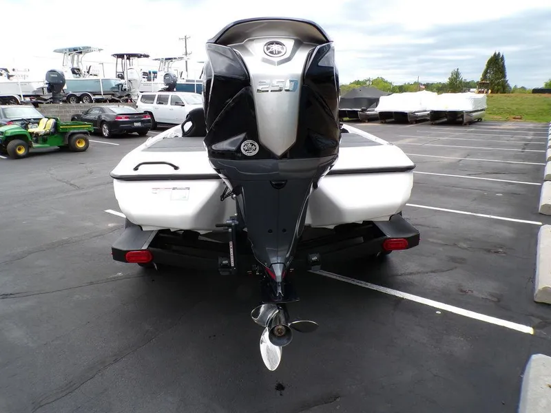 Slide: The Image of 2025 Skeeter ZXR21SE boat with powerful outboard motor in a parking lot. - 8