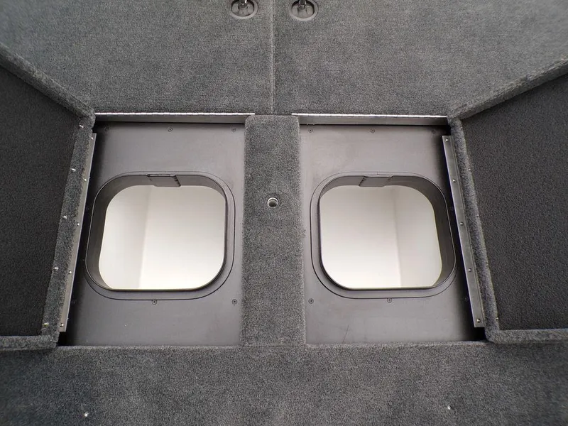 Slide: The Image of 2025 Skeeter ZXR21SE boat storage compartments with open hatches, showcasing interior space. - 9