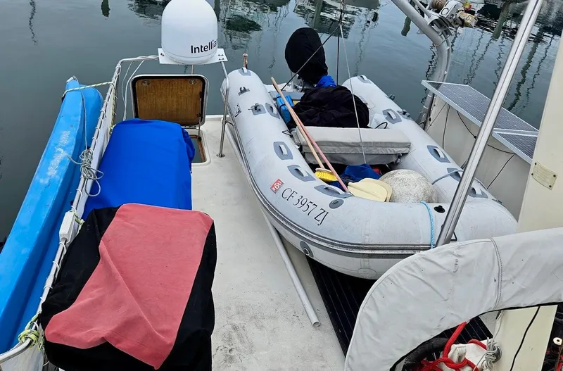 Slide: The Image of 1976 Hatteras 48 LRC yacht deck with inflatable dinghy and marine equipment. - 10