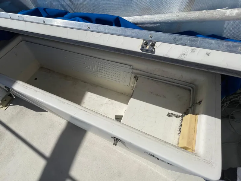 Slide: The Image of Open storage compartment on 1976 Hatteras 48 LRC boat, featuring a white interior. - 12