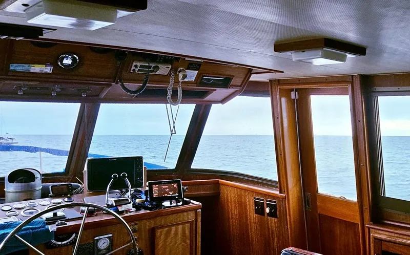 Slide: The Image of 1976 Hatteras 48 LRC yacht interior with ocean view through windows. - 16