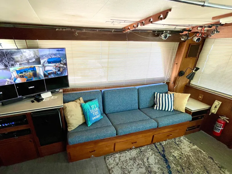 Slide: The Image of 1976 Hatteras 48 LRC interior with blue sofa, TV, and nautical decor. - 24