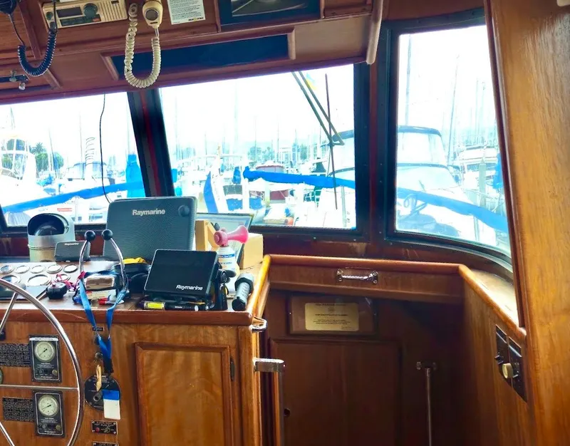 Slide: The Image of Interior view of a 1976 Hatteras 48 LRC yacht helm with navigation equipment. - 26