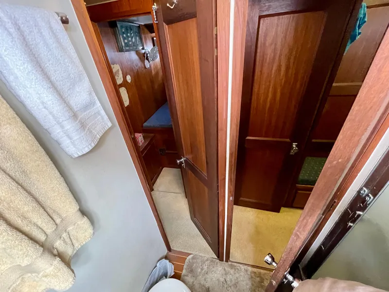 Slide: The Image of Interior view of 1976 Hatteras 48 LRC yacht, featuring wooden doors and cozy cabin space. - 38