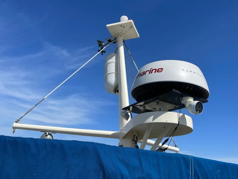 Slide: The Image of Radar equipment on a 1976 Hatteras 48 LRC against a clear blue sky. - 9