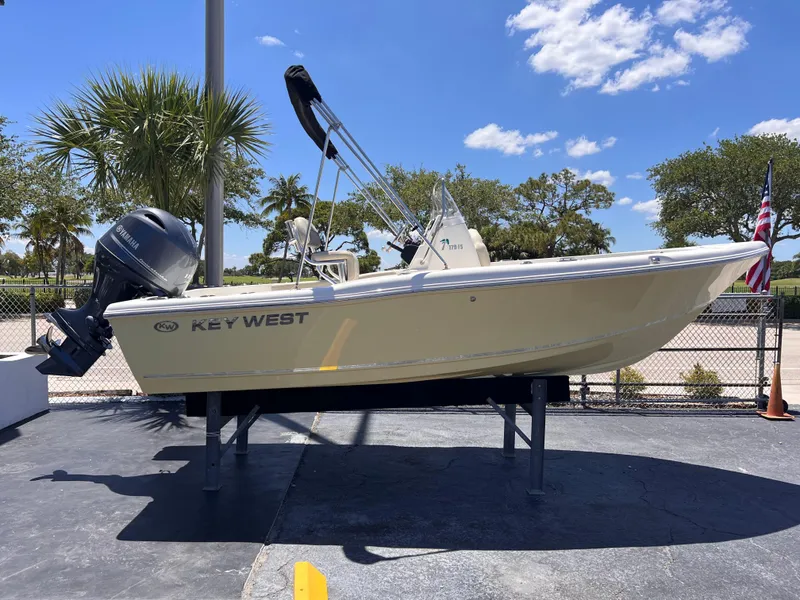 The Image of 2025 Key West 179 FS boat displayed outdoors on a stand, under a clear blue sky. - 1