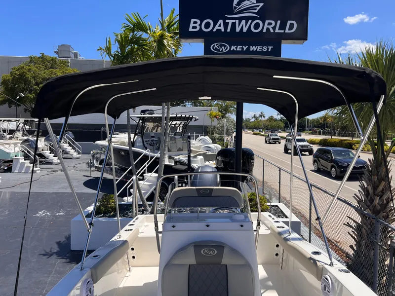 Slide: The Image of 2025 Key West 179 FS boat at Boatworld dealership under sunny skies. - 11
