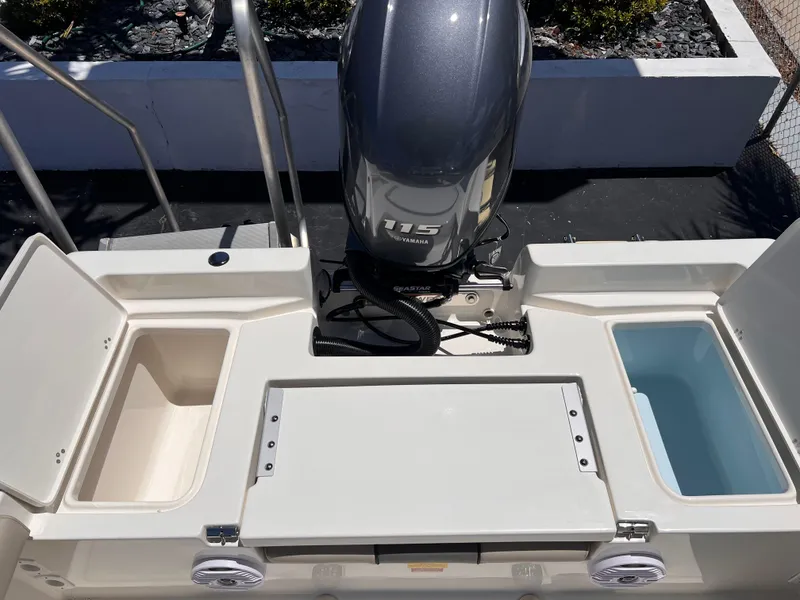 Slide: The Image of 2025 Key West 179 FS boat with Yamaha 115 outboard motor, featuring storage compartments. - 13