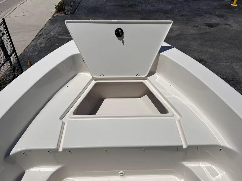 Slide: The Image of 2025 Key West 179 FS boat with open storage compartment on deck. - 16