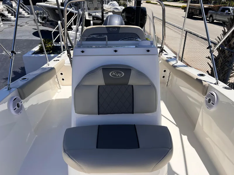 Slide: The Image of 2025 Key West 179 FS boat interior with gray seating and steering console. - 17