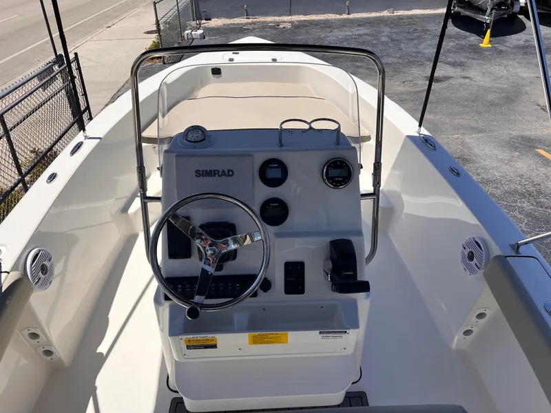 Slide: The Image of 2025 Key West 179 FS boat interior with steering console and Simrad electronics. - 19