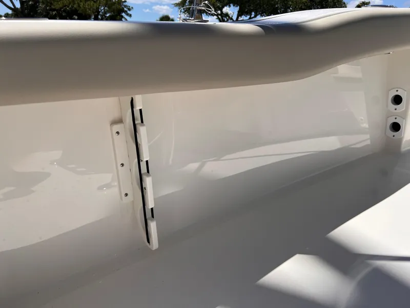 Slide: The Image of 2025 Key West 179 FS boat interior detail with hinge and smooth white finish. - 24