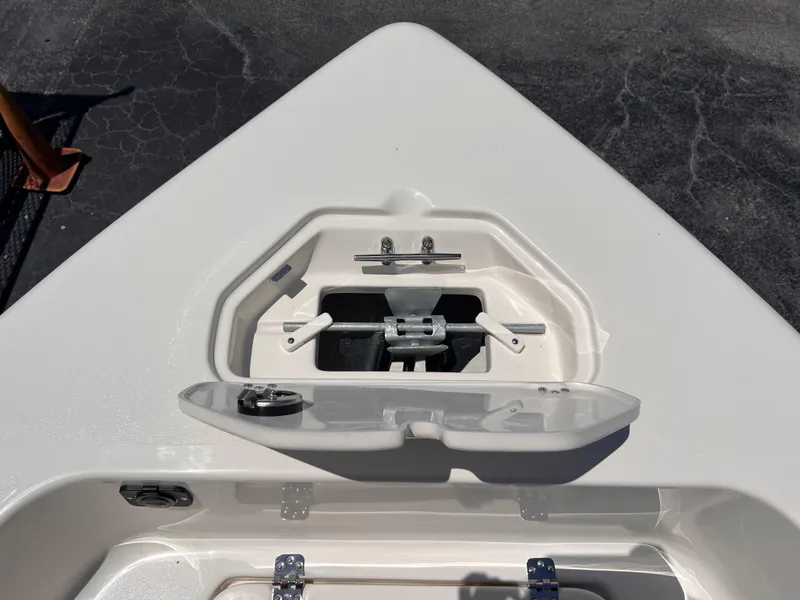 Slide: The Image of 2025 Key West 179 FS boat anchor compartment, open on a sunny day. - 27