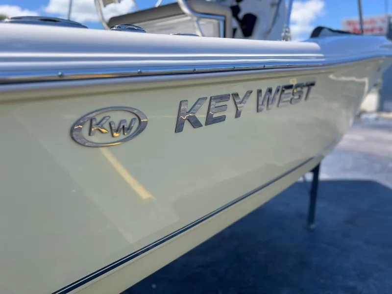 Slide: The Image of 2025 Key West 179 FS boat side view with logo and clear sky background. - 29