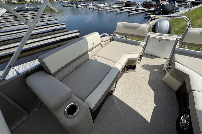 Slide: The Image of 2025 Tahoe Pontoon LTZ Quad Lounger Shift with luxurious seating by the dock. - 10