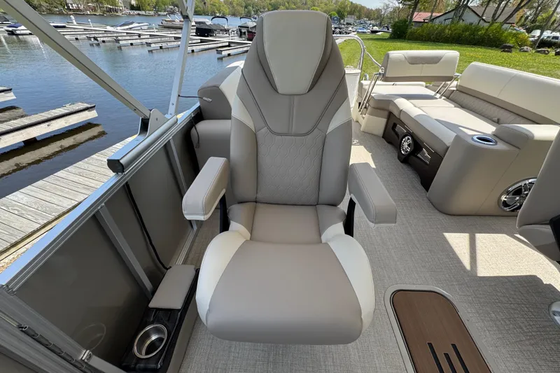 Slide: The Image of 2025 Tahoe Pontoon LTZ Quad Lounger Shift with luxurious seating, dockside view. - 12