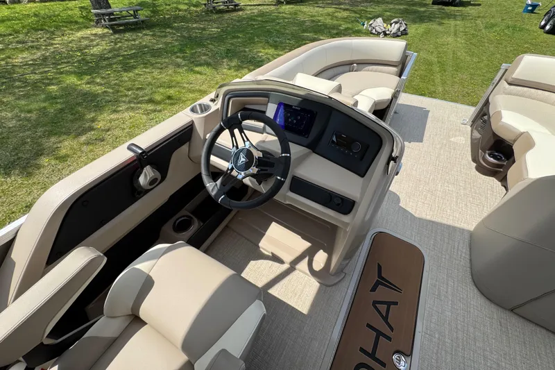 Slide: The Image of 2025 Tahoe Pontoon LTZ Quad Lounger Shift interior with steering wheel and seating. - 13