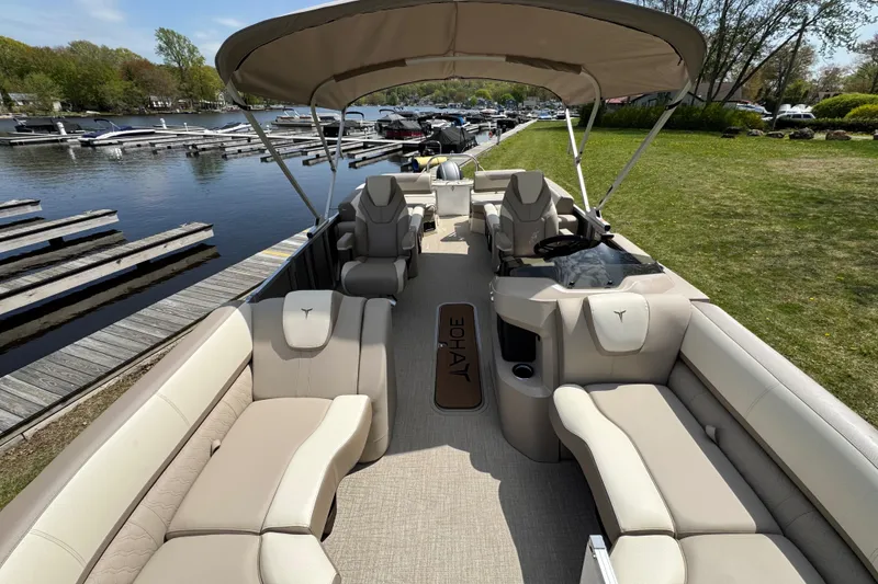 Slide: The Image of 2025 Tahoe Pontoon LTZ Quad Lounger Shift on a scenic lakeside dock. - 14