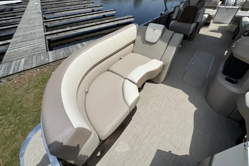 Slide: The Image of 2025 Tahoe Pontoon LTZ Quad Lounger Shift with elegant seating, dockside view. - 17