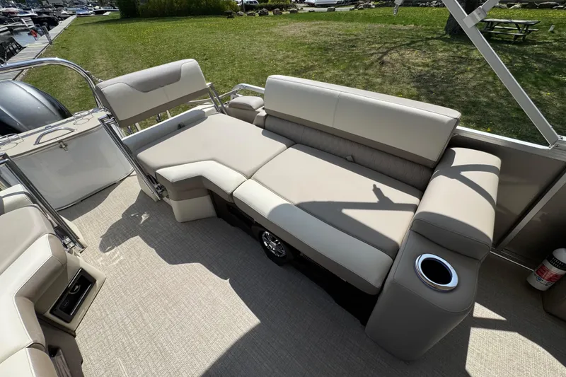 Slide: The Image of 2025 Tahoe Pontoon LTZ Quad Lounger Shift with beige seating and cup holder on deck. - 9