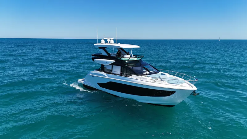 Slide: The Image of A luxurious motor yacht with a sleek design cruising on open sea under clear skies. - 5