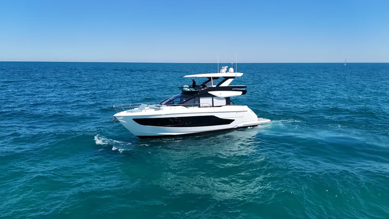 Slide: The Image of A luxurious motor yacht with a sleek design cruising on open sea under a clear sky. - 4