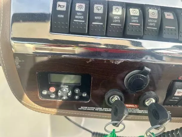 Slide: The Image of Control panel of a 2014 Chaparral 307 SSX boat with switches and keys. - 11