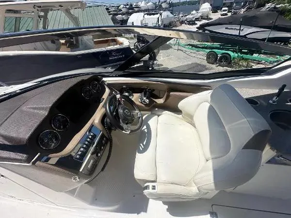 Slide: The Image of 2014 Chaparral 307 SSX boat cockpit with steering wheel and control panel. - 12