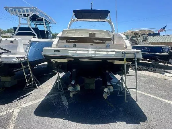 Slide: The Image of 2014 Chaparral 307 SSX boat on display in a parking lot. - 4