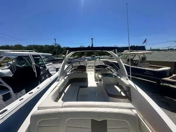 Slide: The Image of 2014 Chaparral 307 SSX boat with spacious seating, docked under clear blue sky. - 6