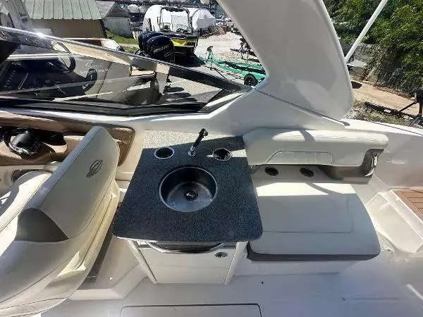 Slide: The Image of 2014 Chaparral 307 SSX boat interior with sink and seating area. - 7