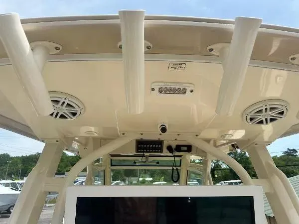 Slide: The Image of 2018 Scout 350 LXF boat interior with speakers and rod holders. - 13