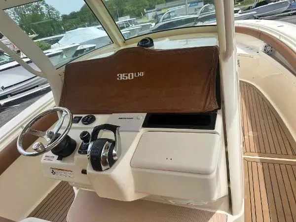 Slide: The Image of 2018 Scout 350 LXF boat dashboard with steering wheel and controls. - 14
