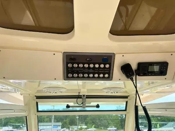 Slide: The Image of 2018 Scout 350 LXF boat dashboard with control panel and radio equipment. - 18
