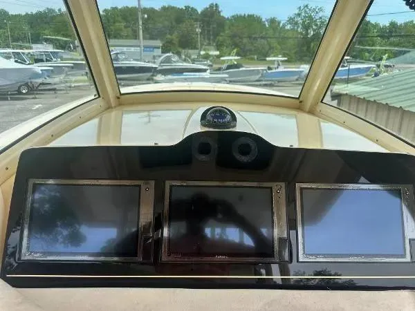 Slide: The Image of Dashboard of a 2018 Scout 350 LXF boat with three display screens. - 19