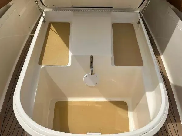 Slide: The Image of 2018 Scout 350 LXF boat storage compartment with beige and white interior. - 21
