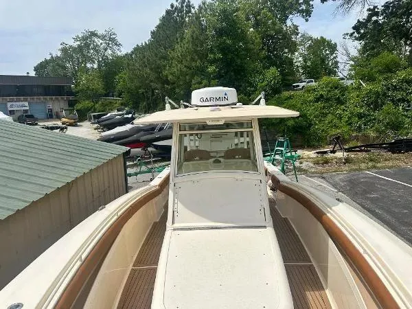 Slide: The Image of 2018 Scout 350 LXF boat with Garmin equipment, docked outdoors. - 22