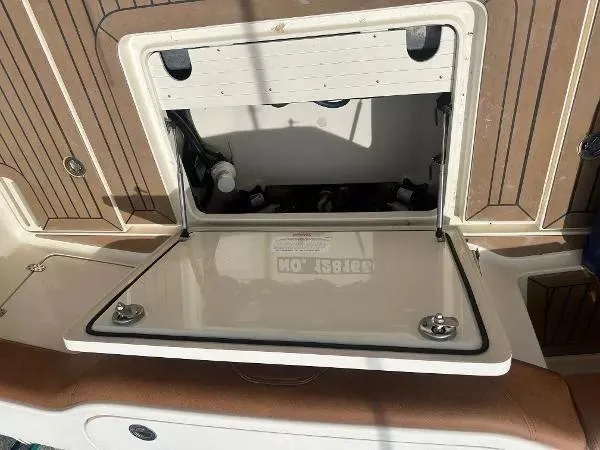 Slide: The Image of Open storage compartment on 2018 Scout 350 LXF boat deck. - 9