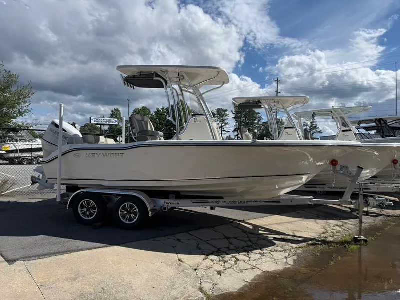 Slide: The Image of 2025 Key West 219 FS boat on trailer under cloudy sky. - 1