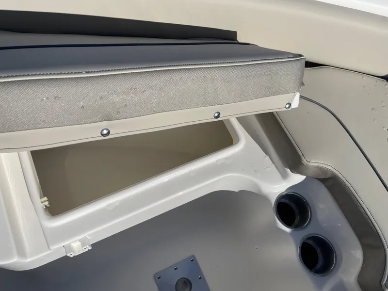 Slide: The Image of 2025 Key West 219 FS boat interior with storage compartment and cup holders. - 10