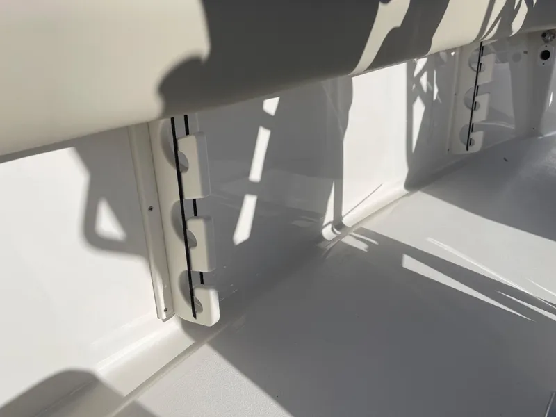 Slide: The Image of 2025 Key West 219 FS boat interior detail with white seating and shadow play. - 14