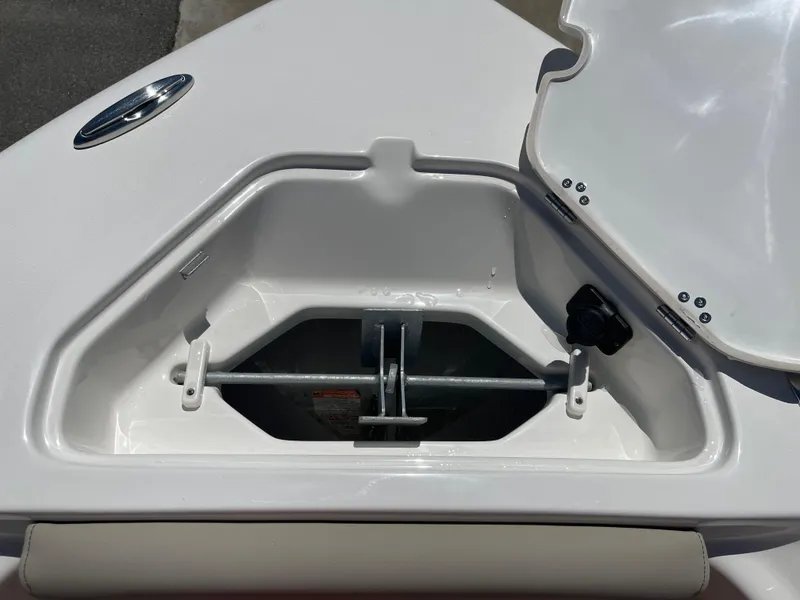 Slide: The Image of Anchor storage compartment on 2025 Key West 219 FS boat, open lid, white interior. - 16